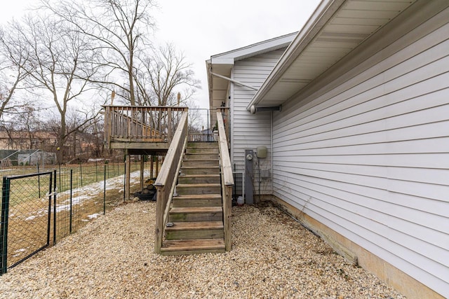 exterior space featuring a deck, fence, and stairway