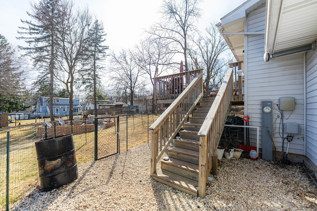 view of yard with stairway, a deck, and fence