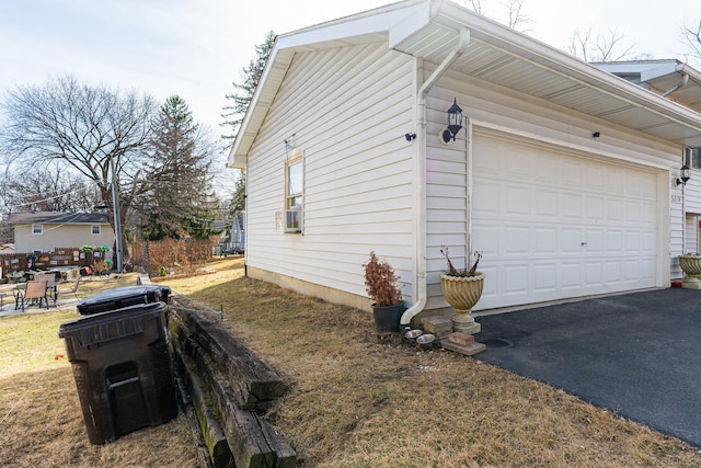 view of property exterior featuring aphalt driveway and cooling unit