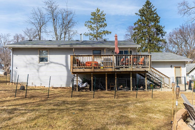 back of property with a yard, stairway, a deck, and fence