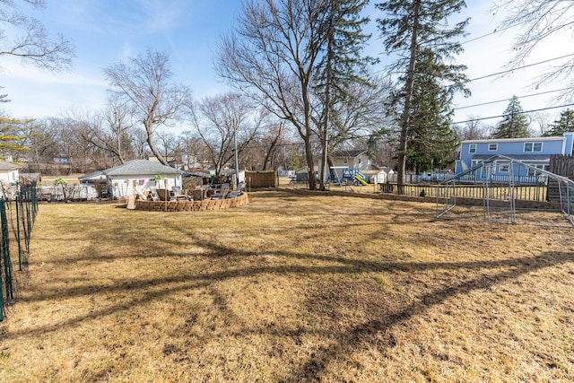 view of yard with playground community and fence