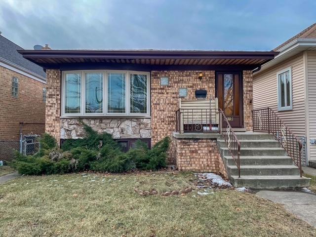 5712 N Avondale Ave, Chicago, IL 60631 - view of front of home with a front yard, stone siding, and brick siding