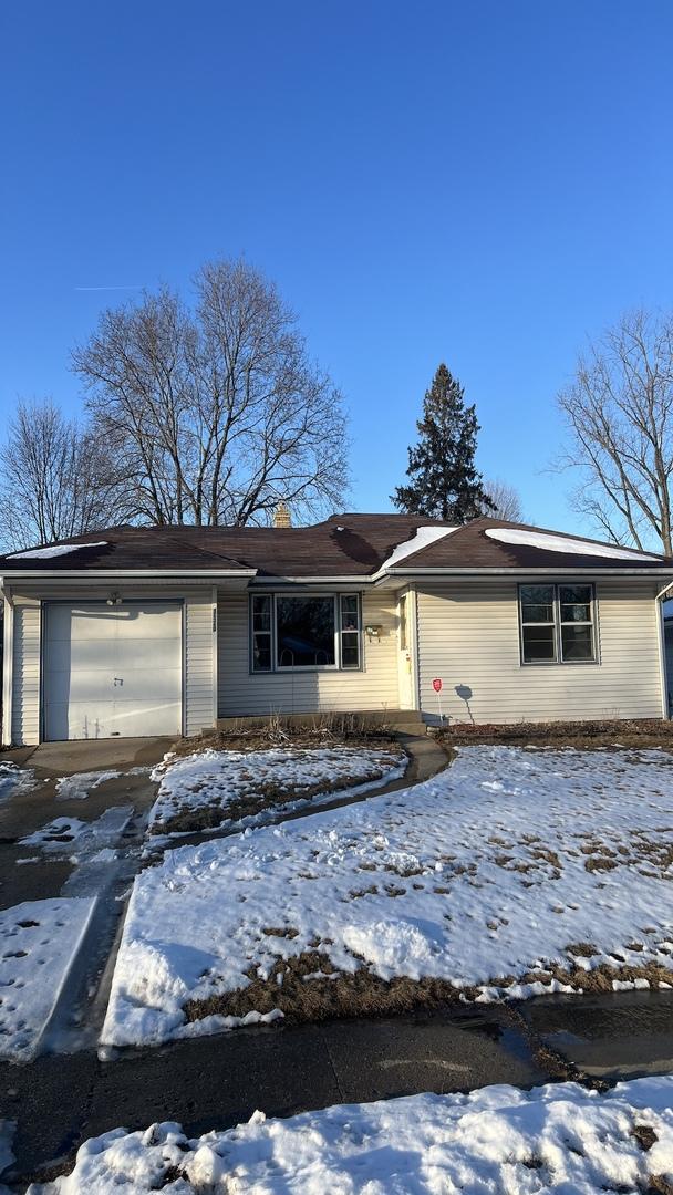 view of front of home featuring a chimney and an attached garage