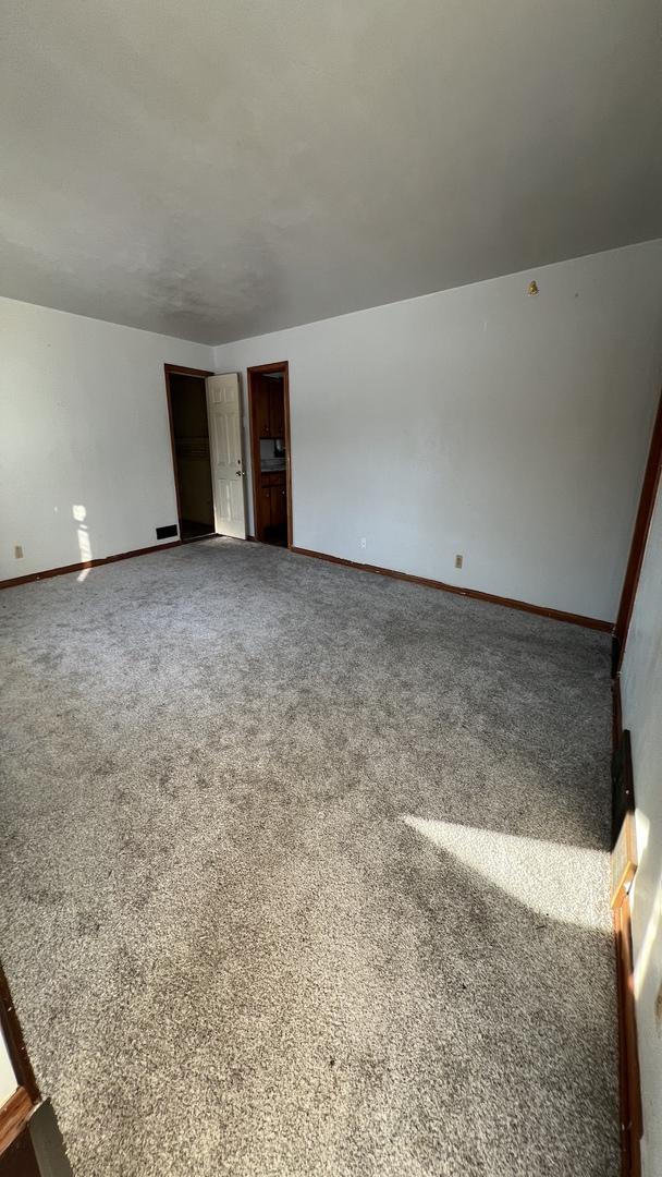 interior space featuring carpet flooring and baseboards