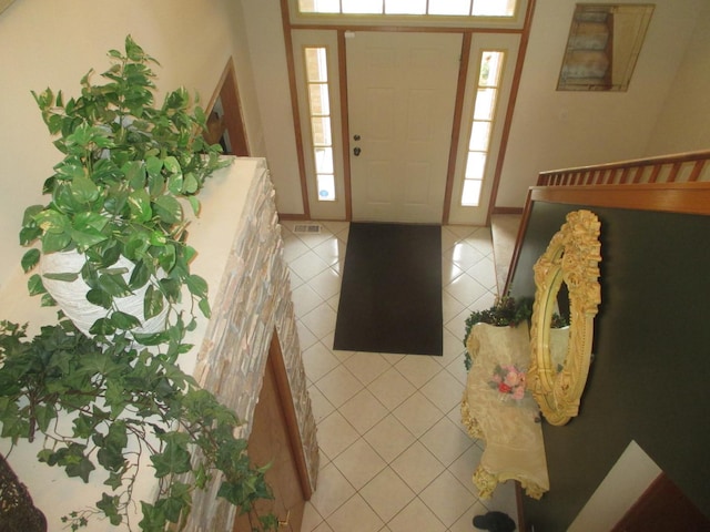 foyer entrance with light tile patterned floors and visible vents