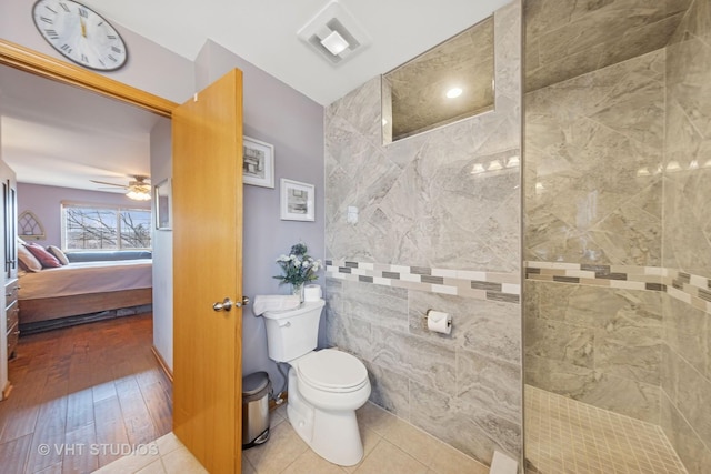 ensuite bathroom featuring ensuite bathroom, toilet, visible vents, a ceiling fan, and walk in shower