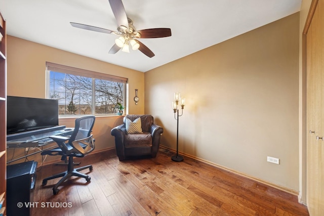 office area with baseboards, a ceiling fan, and wood finished floors