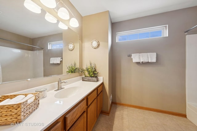 bathroom featuring a shower, a healthy amount of sunlight, and vanity