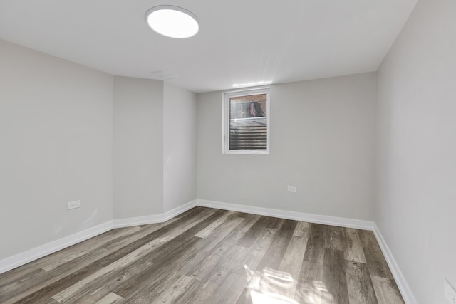 unfurnished room featuring wood finished floors and baseboards