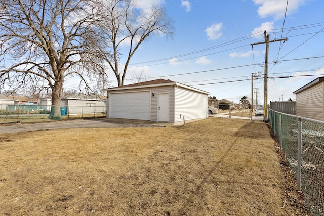 view of yard with an outbuilding, fence, and a detached garage