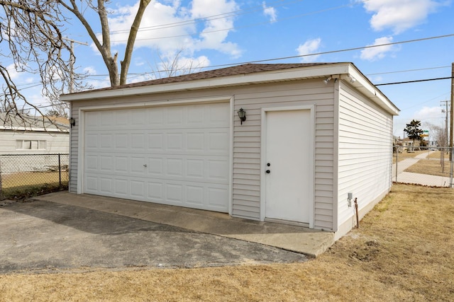 detached garage featuring fence