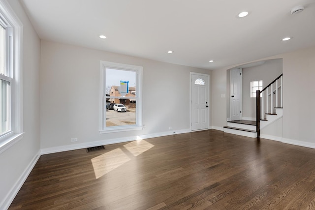 entryway with stairway, visible vents, dark wood-style flooring, and recessed lighting