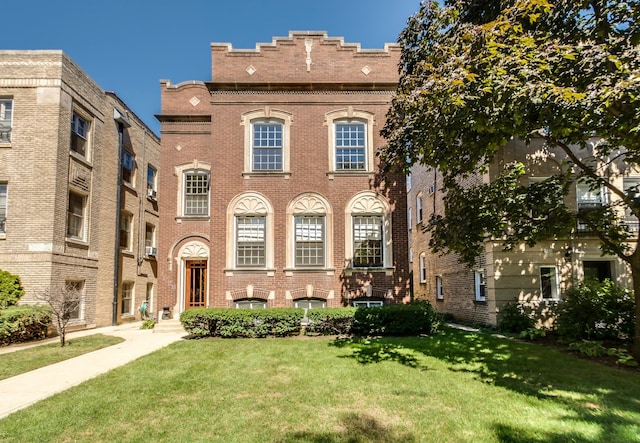 view of front of home with brick siding and a front lawn