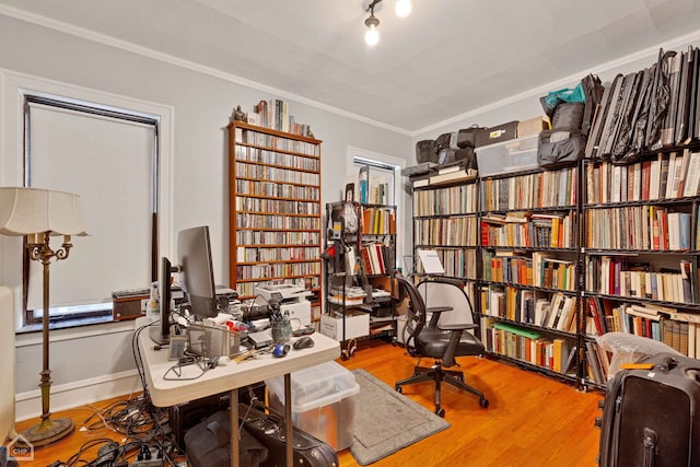 home office featuring baseboards, wood finished floors, and crown molding