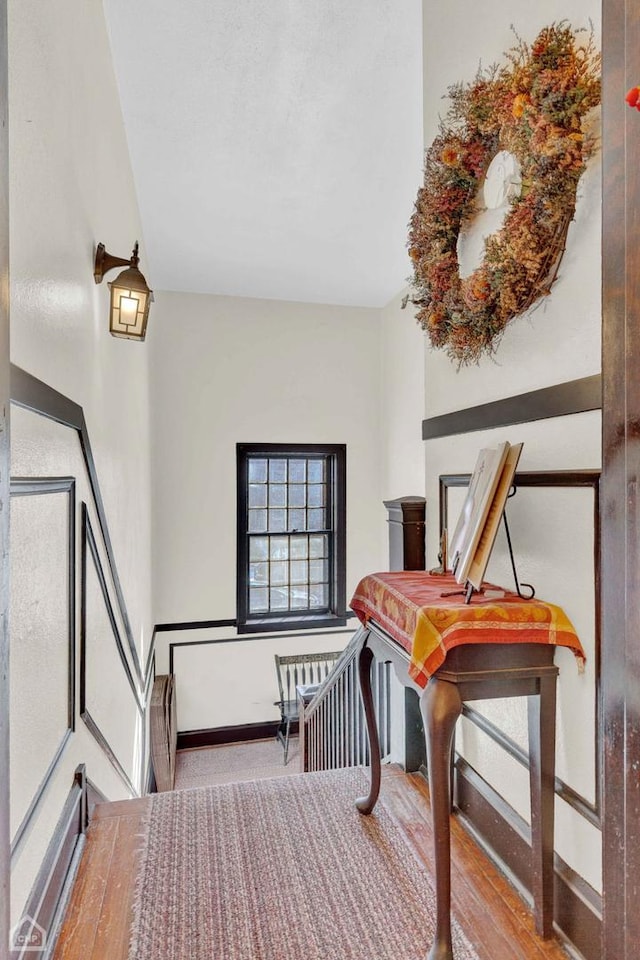 interior space with wood finished floors and baseboards