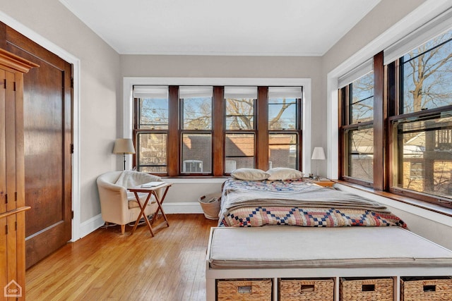 bedroom featuring light wood-type flooring and baseboards