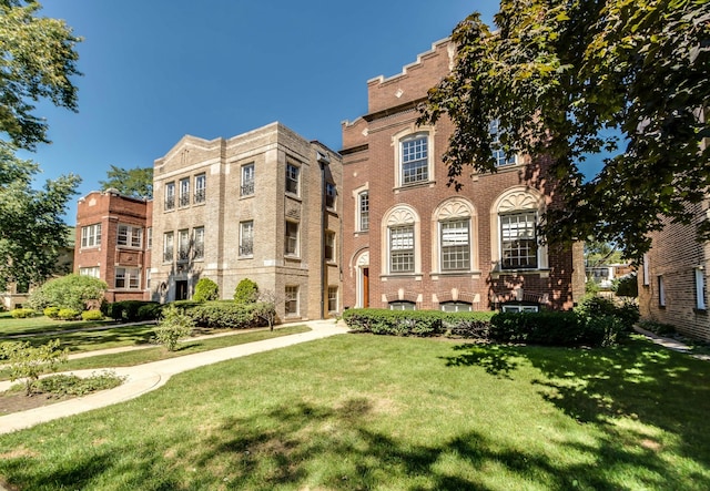 view of front of property with brick siding and a front lawn