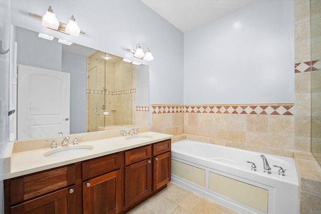 full bathroom featuring double vanity, a sink, a shower stall, and a bath