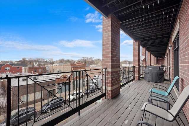 wooden deck featuring a grill