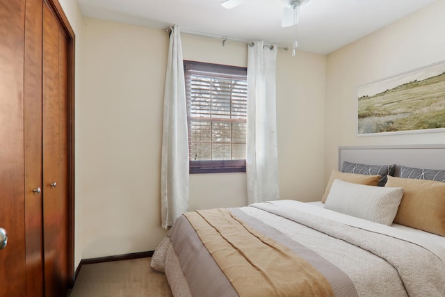 bedroom with a closet, a ceiling fan, and baseboards