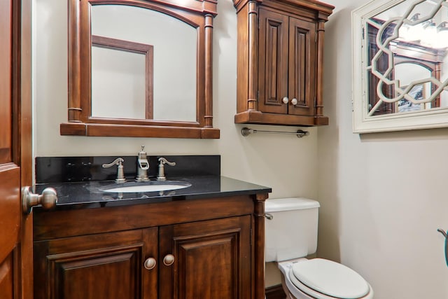 bathroom with toilet and vanity