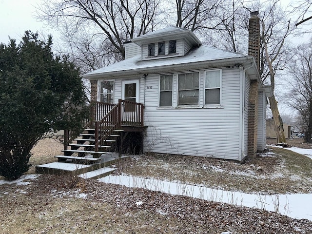 bungalow-style home featuring a chimney