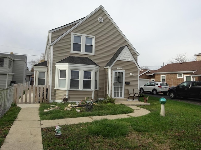 bungalow with fence and a front lawn