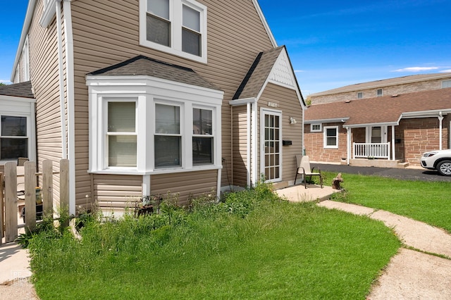 3706 Ruby St, Schiller Park, IL 60176 - view of front facade with a front yard and a shingled roof