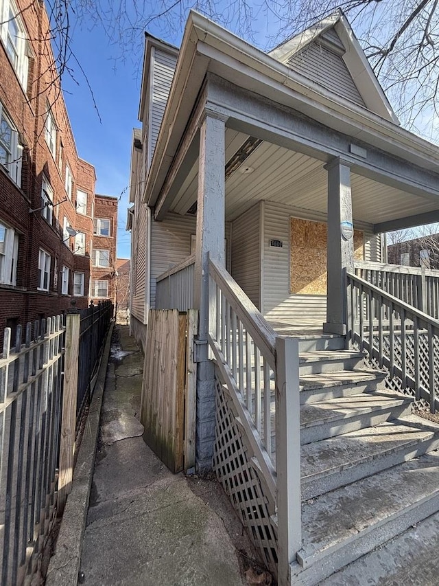 exterior space with covered porch and fence