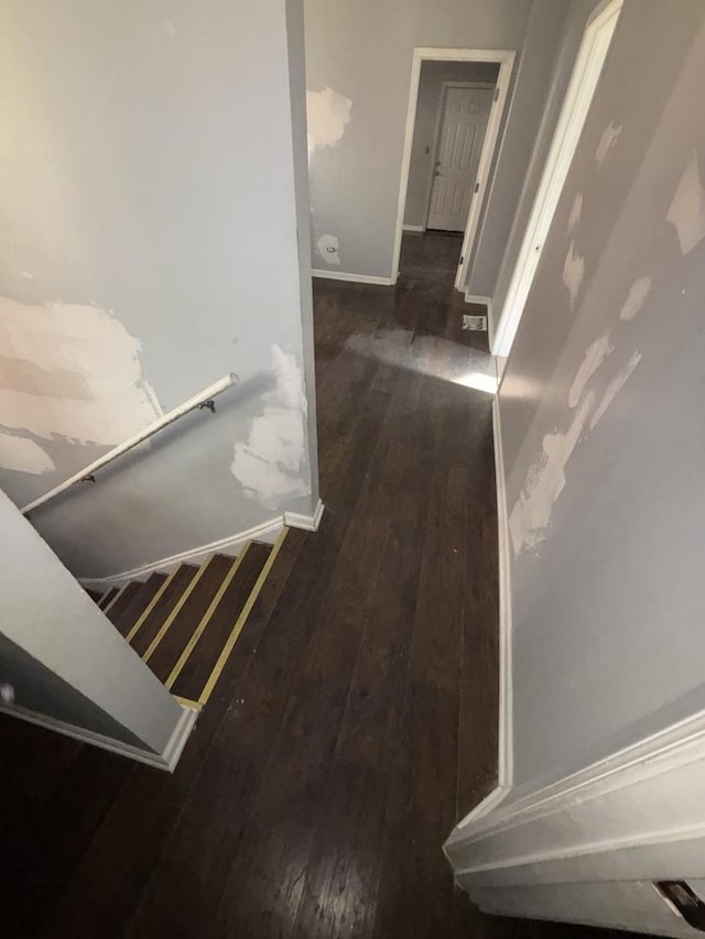 hallway featuring hardwood / wood-style floors and baseboards