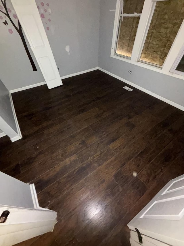 interior space with dark wood finished floors and baseboards