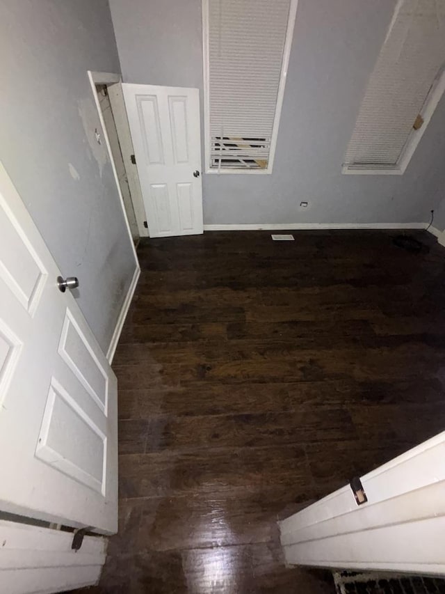 interior space with wood finished floors and baseboards