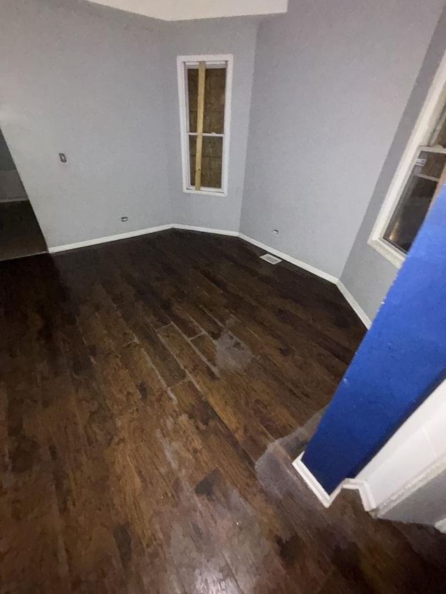 interior space featuring baseboards and wood finished floors