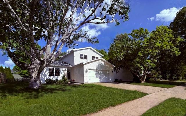 1816 Sadler Dr, Champaign, IL 61821 - view of front facade featuring driveway, a front yard, and stucco siding