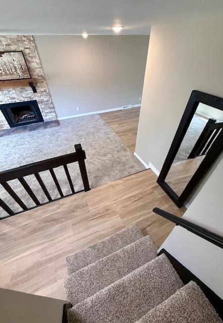 1816 Sadler Dr, Champaign, IL 61821 - stairway featuring a fireplace, baseboards, and wood finished floors