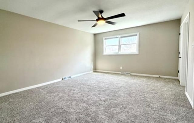 1816 Sadler Dr, Champaign, IL 61821 - spare room with carpet floors, a ceiling fan, and baseboards