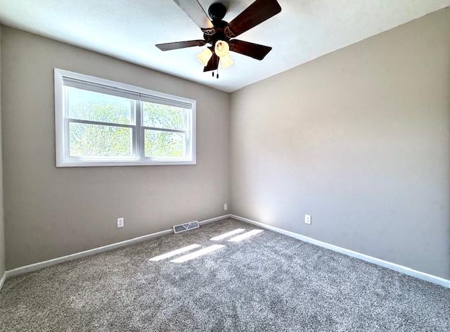 1816 Sadler Dr, Champaign, IL 61821 - empty room with carpet floors, ceiling fan, and baseboards