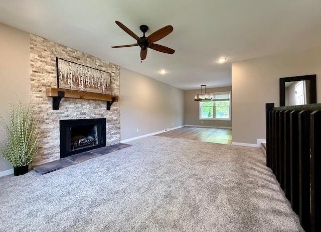 1816 Sadler Dr, Champaign, IL 61821 - unfurnished living room featuring carpet, a fireplace, baseboards, and ceiling fan