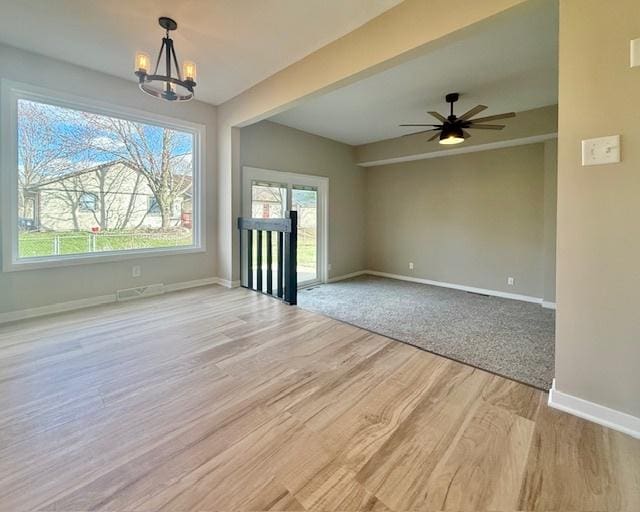 1816 Sadler Dr, Champaign, IL 61821 - unfurnished dining area with wood finished floors, a chandelier, baseboards, and a ceiling fan