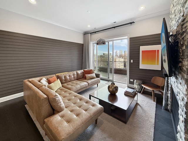 living area with ornamental molding and recessed lighting