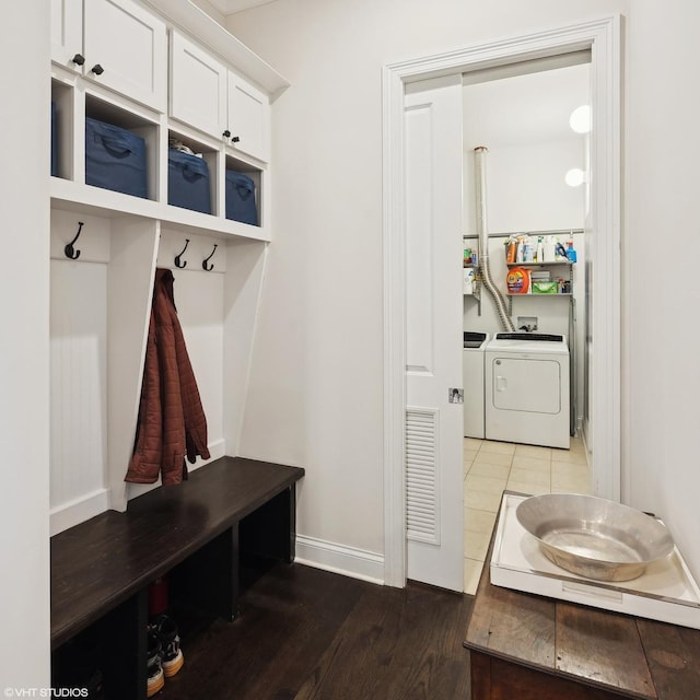 mudroom featuring washer and clothes dryer, wood finished floors, and baseboards