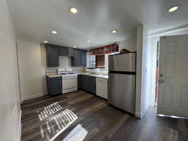 kitchen with white appliances, light countertops, dark wood-type flooring, and gray cabinetry