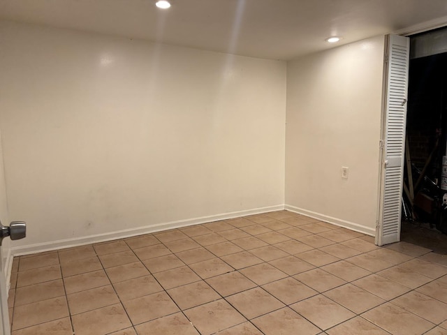 unfurnished room with baseboards and recessed lighting