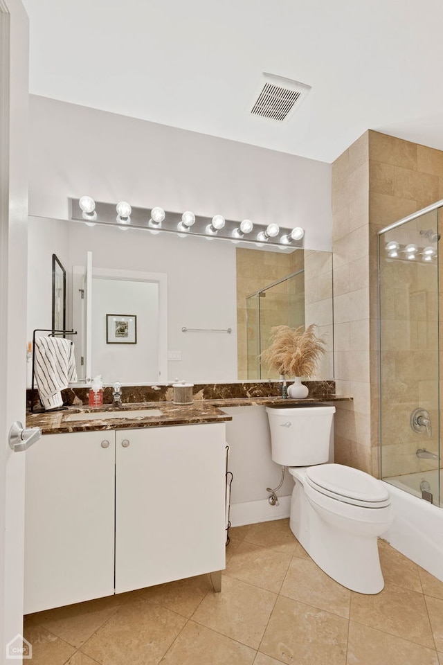 full bath featuring visible vents, toilet, tile patterned floors, combined bath / shower with glass door, and vanity