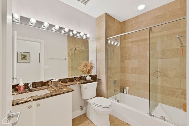 bathroom featuring shower / bath combination with glass door, visible vents, toilet, vanity, and tile patterned flooring