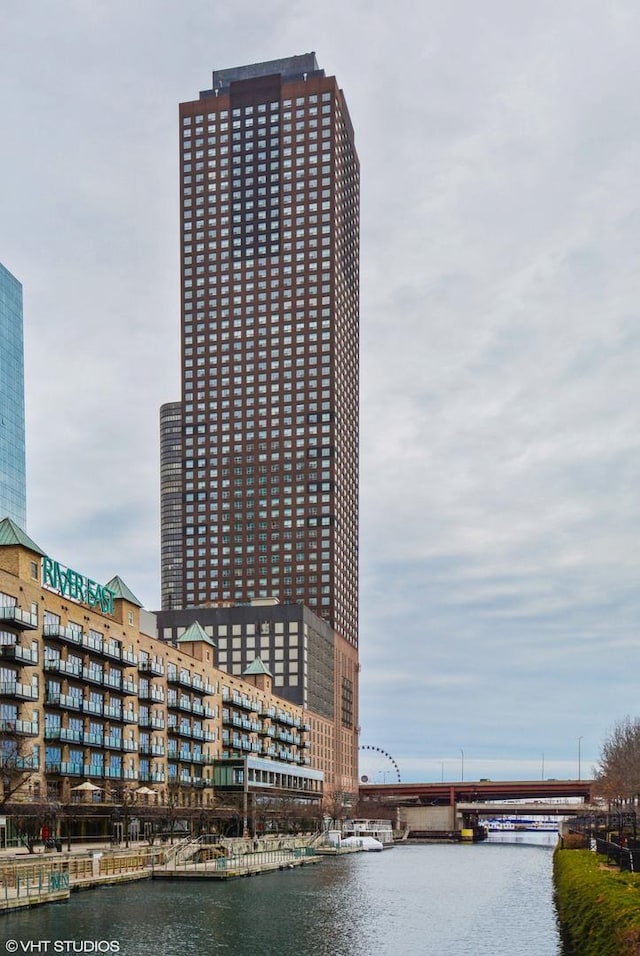 view of building exterior with a view of city and a water view