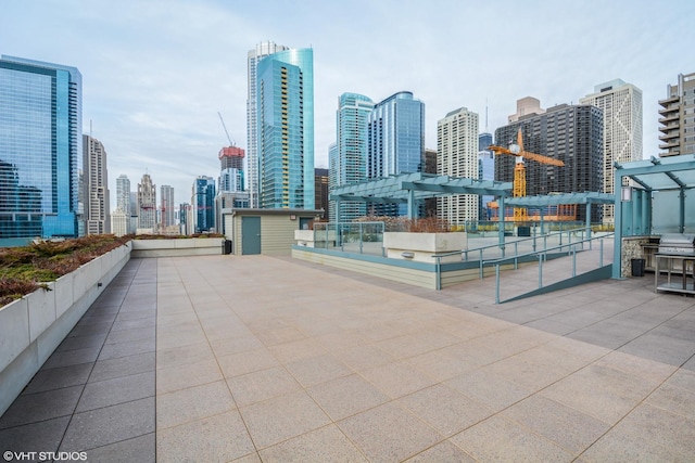 view of patio / terrace featuring a view of city and a pergola