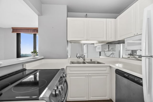 kitchen with electric stove, light countertops, white cabinets, a sink, and dishwasher