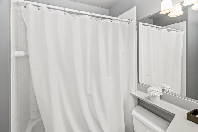 full bath featuring shower / bath combo with shower curtain and toilet