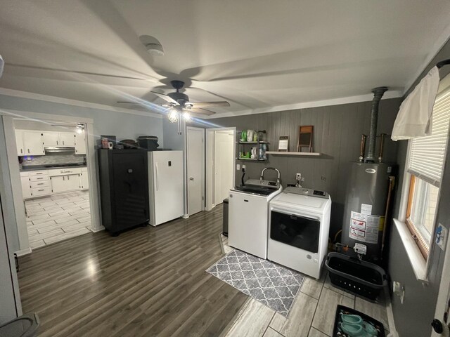 clothes washing area featuring laundry area, dark wood-style flooring, a ceiling fan, water heater, and washing machine and clothes dryer